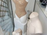 a mannequin in the corner of a room with a mannequin in front of it
