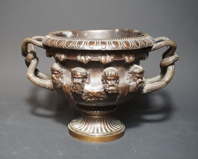 a large silver vase with two lions on it
