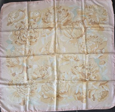 a close up of a pink and yellow floral print table cloth