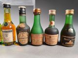 several bottles of alcohol are lined up on a table