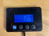 a digital clock on a table with a charger