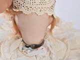 a close up of a doll with a hat on it ' s head