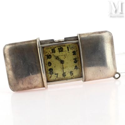 a silver watch that is sitting on a white surface