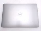 dell laptop computer sitting on a white surface with a dell logo on the screen