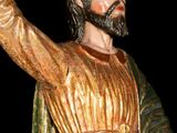 a statue of jesus holding a cross in his hand
