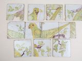 a picture of a picture of birds and leaves on the wall