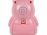 a pink toy bear that is sitting on top of a speaker