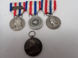 three medals and a medal on a white surface