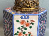 a small decorative box with a bird on top of it