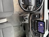 a car dashboard with a steering wheel and a cell phone in it