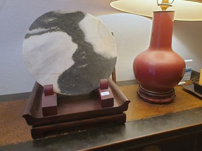 une photo d'une table sur laquelle se trouvent une lampe et une pierre