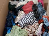 a box full of clothes that is sitting on the floor