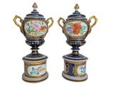 pair of decorative vases with floral designs on them on a white background