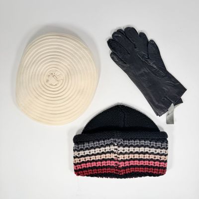 une photo montrant un bonnet, des gants et une écharpe posés sur une table