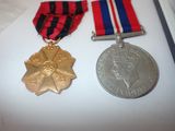 two medals and a medal sitting on a table