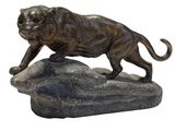 statue of a lion on a rock on a white background
