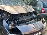 a car that is sitting in the grass with its hood up