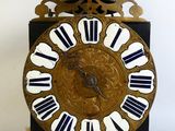 a black and gold clock with white numbers on it