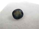 a close up of a blue sapphire stone on a white surface