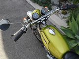 a yellow motorcycle parked on the side of the road