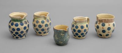 several different types of vases are lined up on a gray surface