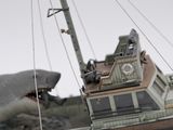 a model of a boat with a shark in the background