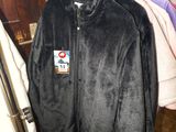 jacket hanging on a rack in a room with clothes on hangers