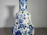 a blue and white vase sitting on a table