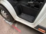 a white truck with its door open on the side of the road