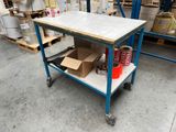 a blue cart with a marble top in a warehouse