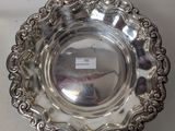 an antique silver plate with a decorative design on the rim