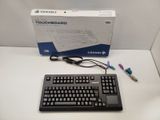 a computer keyboard and mouse sitting on a table