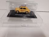 the yellow car is in a clear display case on a white surface