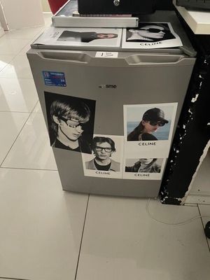 a refrigerator that has pictures on it in a kitchen