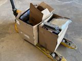 a cardboard box on a pallet with a bunch of items in it