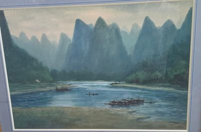 a picture of a painting of a river with mountains in the background