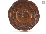 an image of a brown plate with a picture of a man on it