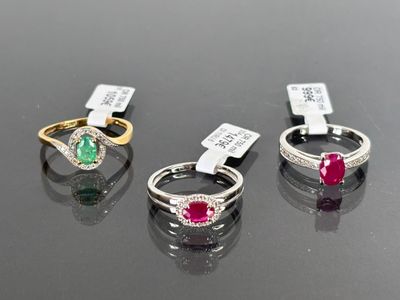 three different colored stones are displayed on a black surface