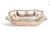 an antique silver plate with a decorative design on the rim