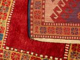 an image of a red rug with a blue border on top of it