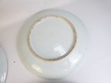a white plate with a brown rim sitting on a table