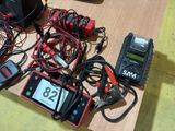 a table with a lot of wires and a cell phone