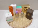 many different perfumes on a tray on a table