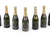 six bottles of champagne in a row on a white background