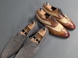 two pairs of shoes sitting on top of a table next to each other