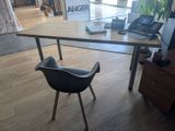 a desk with a chair and a laptop on it