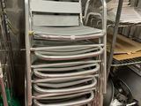 a lot of chairs that are stacked up in a room