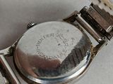 a watch sitting on a table with a chain around it