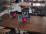 many tables and chairs in a restaurant with a red apple on the table