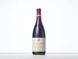 a bottle of red wine sitting on top of a table